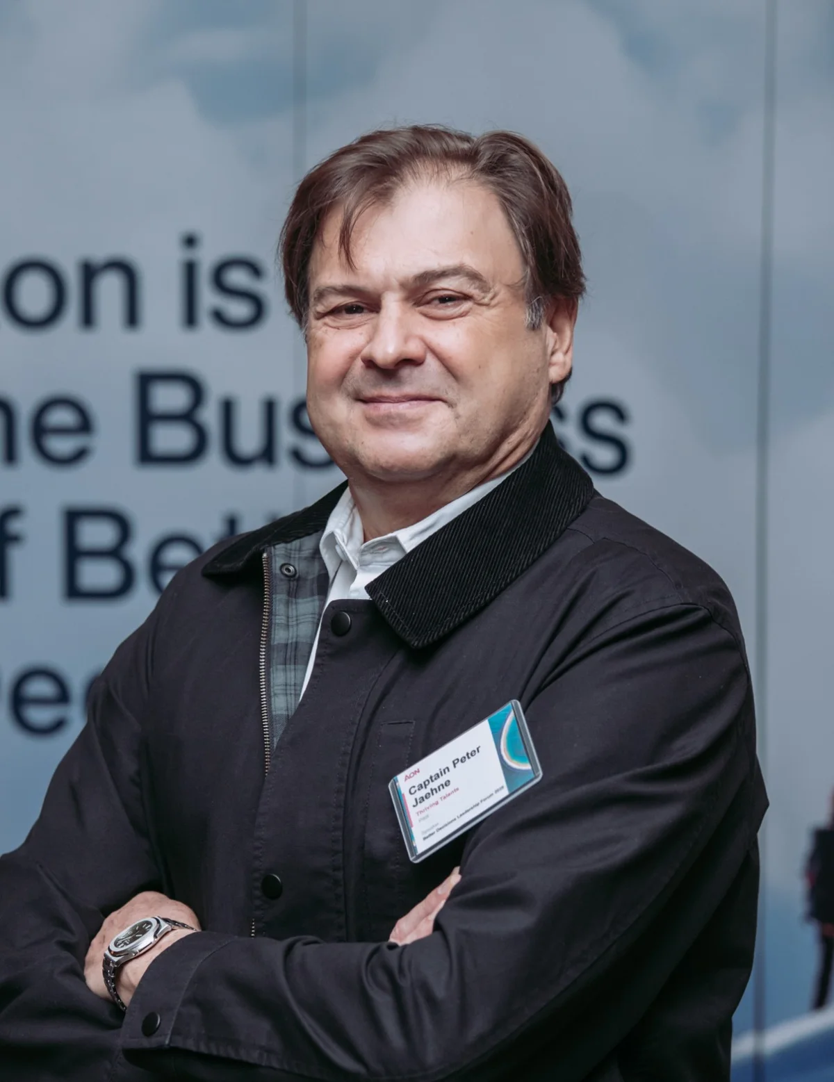 Peter at a leadership forum, wearing his speaker badge